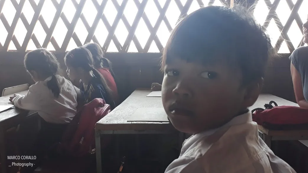 il primo piano di un bambino di Koh Pek all'interno dell'aula della scuola elementare del villaggio