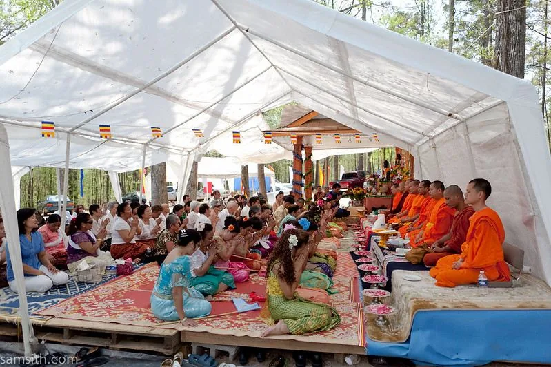 Un gruppo di donne, in abiti eleganti, riceve la benedizione dai monaci durante una cerimonia per celebrare il Capodanno Khmer cambogiano Un gruppo di donne, in abiti eleganti, riceve la benedizione dai monaci durante una cerimonia per celebrare il Capodanno Khmer cambogiano