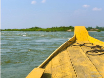 la prua di una caratteristica barca in legno gialla che attraversa il fiume Mekong nei pressi di Kratie